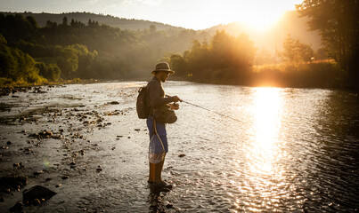 Wall Mural - Fishing background. Fisherman catching on a river.