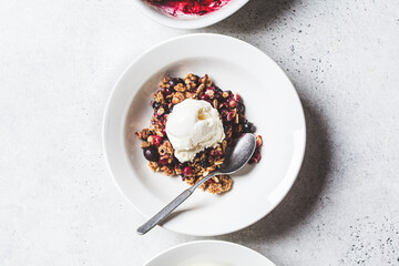 Poster - Berry crumble pie with scoop of ice cream, gray background.