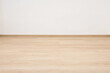 © Paitoon - Empty wooden floor with white concrete wall.