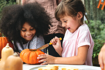 Wall Mural - Young kids carving Halloween jack-o-lantern