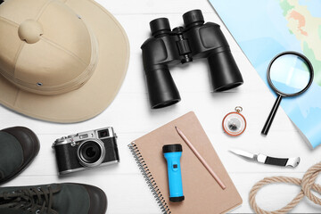 Flat lay composition with different safari accessories on white wooden background