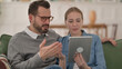 © stockbakers - Couple Reacting to Loss on Tablet at Home