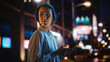 © Gorodenkoff - Beautiful Young Woman Using Smartphone Walking Through Night City Street Full of Neon Light. Smiling Female Using Mobile Phone for Online Shopping, Social Media Posting.