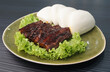braised pork belly meat wrapped with mantou bun Chinese burger  on dark grey wood background dim sum halal menu