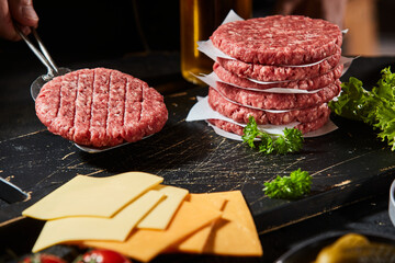 Wall Mural - Freshly prepared ground beef burger patty on spatula