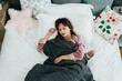 © PR Image Factory - view from top beautiful asian girl under cover is sleeping soundly alone in white bed on a tranquil morning at a bright home bedroom.