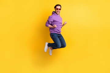 Poster - Full size profile side photo of young man happy positive smile rejoice victory jump isolated over yellow color background