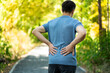 © staras - Back pain when walking outdoors, man with kidney inflammation on nature background