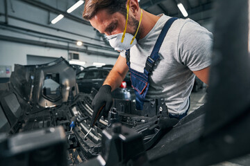 Sticker - Repairman checking spare part condition with wrench