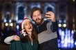 © Ivan - Cute cheerful couple with sparklers rejoices on New Year's Eve c