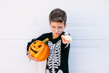 Kid In Halloween Costume Pointing At Camera