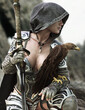 Fantasy female hooded warrior kneeling near a rocky cliff posing with her trusted hawk companion scouting the area. 3d rendering