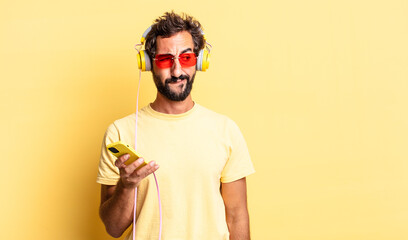 Wall Mural - expressive crazy man feeling sad, upset or angry and looking to the side with headphones