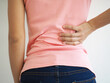 © Bungon - Asian woman suffering from back pain. health care concept. closeup photo, blurred.