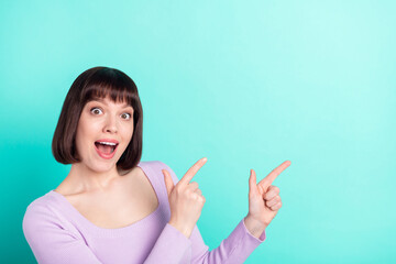 Wall Mural - Photo portrait woman with bob hair surprised showing empty space staring isolated bright turquoise color background