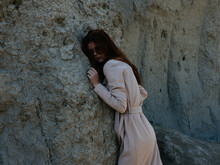 Pretty Woman Posing Near Rocks In The Sand Model Travel