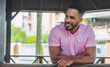 © Julaix - Attractive dark-haired man of Dominican origin laughing, with pink t-shirt