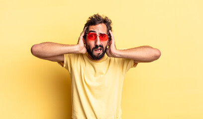 Sticker - expressive crazy bearded man wearing sunglasses with a copy space against yellow wall