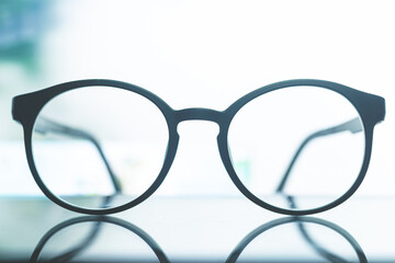 glasses on a white light background,Eye glasses on the white table with sun ray