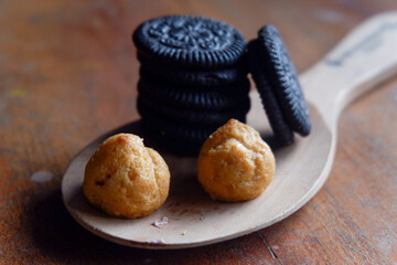 Sticker - Closeup shot of delicious pastries and cookies on a wooden spoon on a table