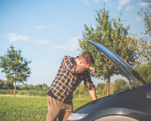 upset man with broken car