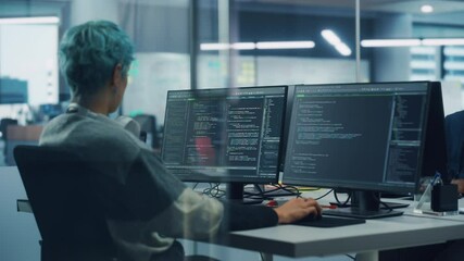 In Diverse Office: Female Programmer is Working on Desktop Computer, Screen Shows Coding Language User Interface. Digital Entrepreneur Creating Modern Software, e-Commerce App Design. Over Shoulder