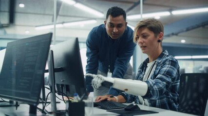 Poster - Teamwork In Diverse Office: Smiling Project Manager Talks with Happy Woman with Disabilitywith Prosthetic Arm to Work on Desktop Computer. Professionals Create e-Commerce Software App Solution