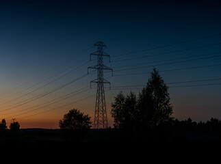 Sticker - lattice cross pylon and high voltage power lines at sunset with tree silhouette in front and copy space