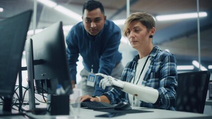 Poster - Teamwork In Diverse Office: Smiling Project Manager Talks with Happy Woman with Disability with Prosthetic Arm to Work on Computer. Professionals Create e-Commerce Software App. Static Rack Focus
