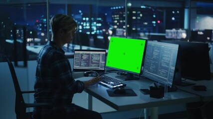 Poster - Diverse Teamwork in Office at Night: Person with Disability Using Prosthetic Arm to Work on Green Screen Chroma Key Computer. Team of Software Engineers work Late to create Innovative App