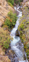 Sticker - Beautiful view of the water stream of the waterfall through the rocks and stones in the forest