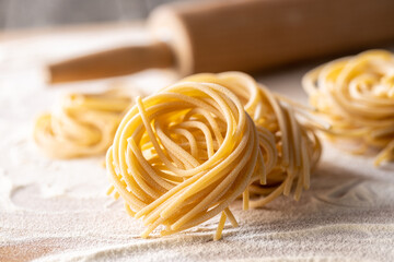 Italian pasta nest. Uncooked spaghetti nest and flour.