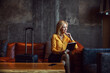 © Dusan Petkovic - A happy businesswoman is sitting in the hotel lobby and checking into the hotel online and looking thoughtfully out the window. He's on a business trip. Telecommunications, travel, business travel