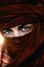Close-up Of Woman With Green Eyes Wearing Red Full Face Veil