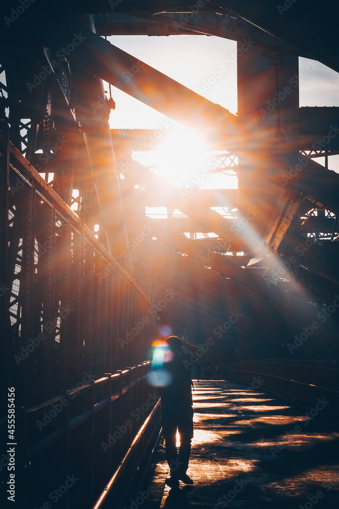 Silhouette of person on bridge during golden hours Stock Photo | Adobe ...