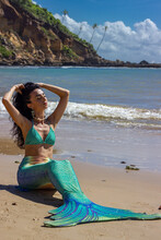 Woman Wearing Green Mermaid Outfit On The Beach
