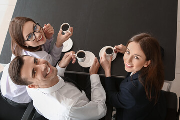 Wall Mural - Business colleagues drinking coffee in office