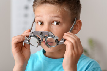 Wall Mural - Little boy undergoing eye test in clinic