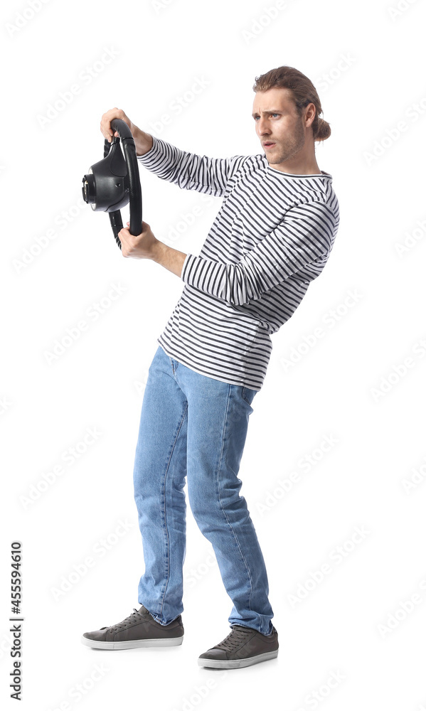 Young man with steering wheel on white background