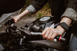 Close up of motorcycle rider hand holding clutch. A motorcycle clutch is a mechanical device that engages or disengages the drive from the engine to the transmission.