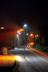 Poster - Vertical shot of street lamps along the road with long exposure