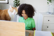 © PintoArt - handsome little boy with computer and cat at home