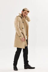 man in beige coat modern style lifestyle isolated background