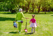 © licvin - Mother with daughter walking in the city Park