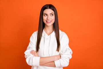 Canvas Print - Portrait of attractive cheerful curious girl folded arms thinking copy space isolated over vibrant orange color background