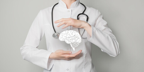 Neurologist doctor, brain specialist. Aesthetic handdrawn highlighted illustration of human brain. Neutral grey background, studio photo and collage.