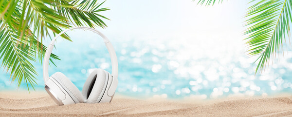 Headphones on tropical sea beach