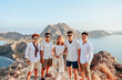 © Gatot - Asian friends group in white shirt posing on a hill with an exotic view of Padar Island