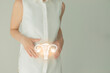 Woman in white clothes holding virtual uterus in hand. Handrawn human organ, detox and healthcare, healthcare hospital service concept stock photo