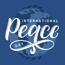 International Peace Day Vector Concept. Modern Brush Calligraphy Peace Day Decorated By Planet Earth Silhouette And Tree Branches.